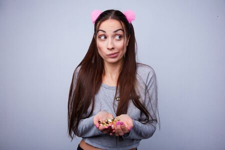 fun girl drinks a lot of pillsの写真素材