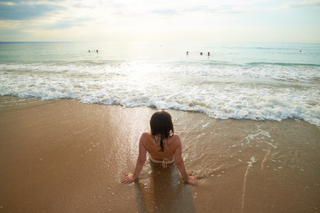 Girl on the shore of the sea backの写真素材