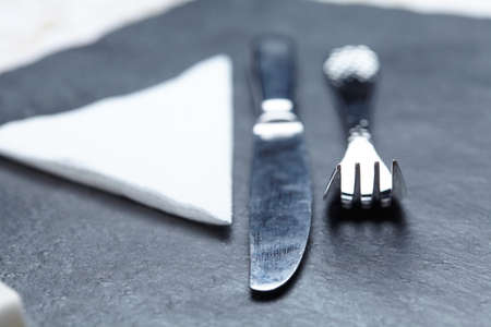 knife and fork on a table a napkinの写真素材