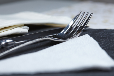 knife and fork on a table a napkinの写真素材