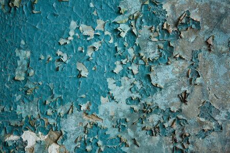 old blue paint on the wall cracking