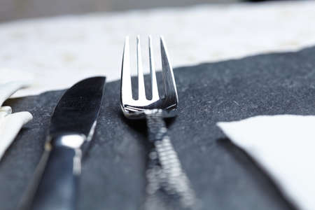 knife and fork on a table a napkinの写真素材