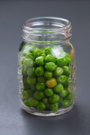 Green peas in a jarの写真素材