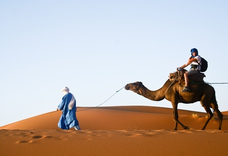 Camel caravan going through the sand dunes in the Sahara Desert, Morocco.のeditorial素材