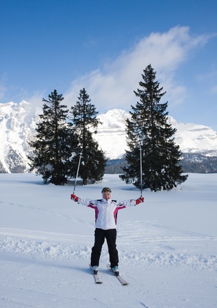 Woman, spruce and mountainの写真素材
