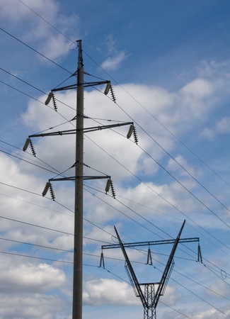 Power transmission tower carrying electricity from different parts of countryの写真素材
