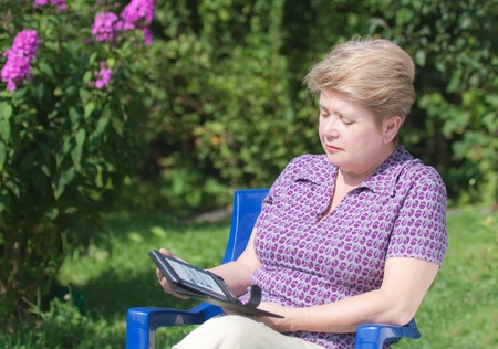 A woman with an e-bookの写真素材