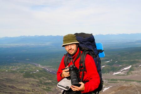 Kamchatka.Turist-photographer on the background of volcanosの写真素材