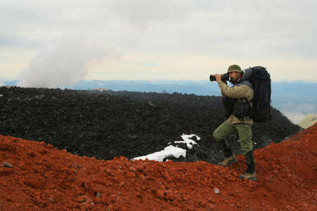 Kamchatka.Turist-photographer from the Avachinsky volcano crater.の写真素材