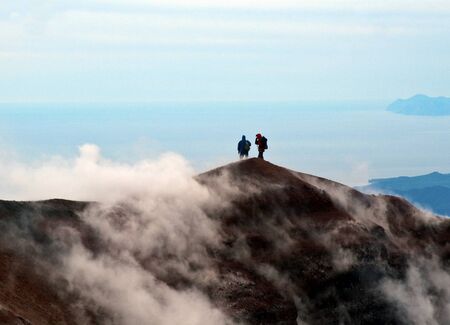 The Tourists look at the Pacific ocean with of the volcano. Kamchatka.の写真素材