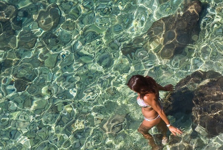 A woman walks into the seaの写真素材