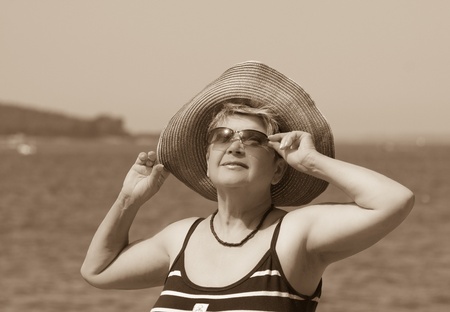 A woman in a hat on a background of the seaの写真素材