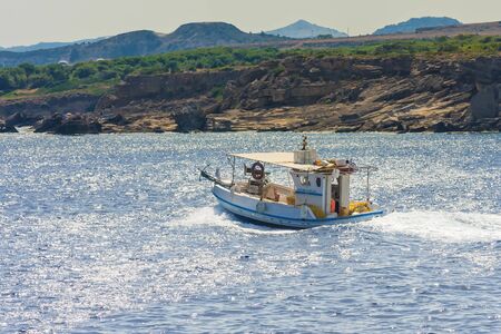 Fishing boat off the coast of the island of Rhodes, Greeceのeditorial素材