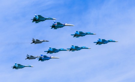 MOSCOW/RUSSIA - MAY 9: 4 Su-34 Fullback bombers, 4 Su-27 Flanker supermanoeuverable and 2 MiG-29 Fulcrum jet fighters form Tactical Wing on parade devoted to Victory Day on May 9, 2015 in Moscow.のeditorial素材