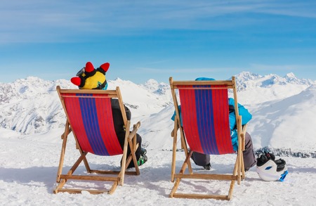 View of men resting on chair in mountains.  Ski resort Livigno. Italyの写真素材