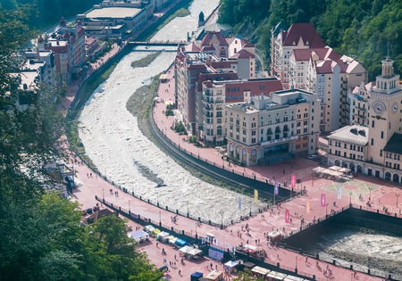 View of the embankment of the river Mzymta and central area ski resort Rosa Khutor. Sochi, Russia.の写真素材
