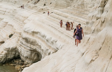 Unidentified peoplel goes on a slope of white cliff called "Scala dei Turchi" in Sicily, near Agrigento. Italyのeditorial素材