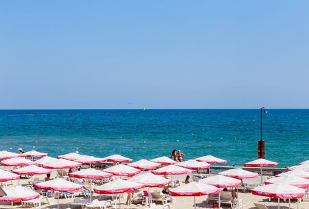 The Balchik seaside, beach with sands, sun umbrellas and blue water.のeditorial素材
