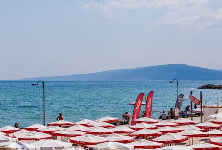 The Balchik seaside, beach with sands, sun umbrellas and blue water.のeditorial素材