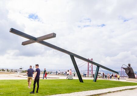Cross in front of the monument to Jesus Christ and Statue of Virgin Mary in Lisbon  Portugalのeditorial素材