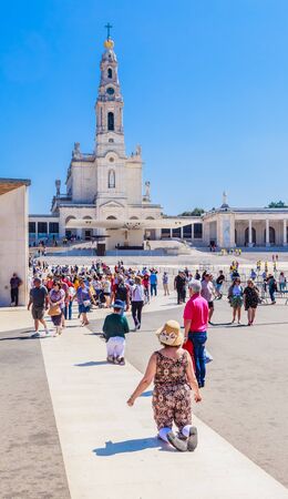 Religious pilgrims kneeling and walking at the Sanctuary of Fatima, which is also referred to as the Basilica of Our Lady of Fatima, Portugalのeditorial素材