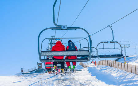 People having fun in Sunny Day on Grandvalira Ski lift in Andorra.のeditorial素材