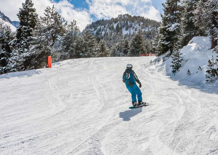 Snowboarder on the slopes of the Ski resort GrandVallira. Pyrenees mountains. Andorra.のeditorial素材