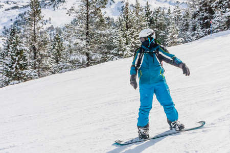 Snowboarder on the slopes of the Ski resort GrandVallira. Pyrenees mountains. Andorra.のeditorial素材