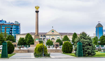 Chechen Republic. Monument "Grozny - a city of military glory" on the Abubakar Kadyrov Square and city mayor's office with portraits of Vladimir Putin and Akhmad Kadyrov on the facadeのeditorial素材