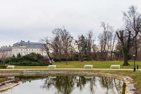 Green park with a view of the Beautiful baroque Festetics Castle in Keszthely Hungary, reflection in the lake pondのeditorial素材
