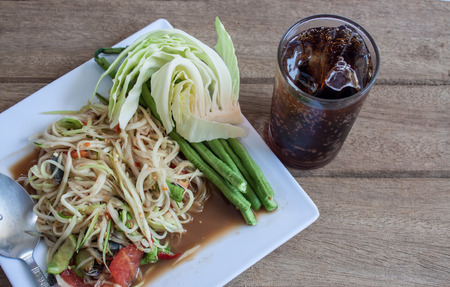 Papaya Salad, Thai call "Som tum" the most famous thai salad combination of green papaya, green beans, carrots, garlic, fresh chili, cherry tomatoes and carrots with sliced fresh lettuceの写真素材
