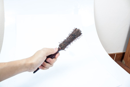 Old big wooden hairbrush, on a white backgroundの写真素材