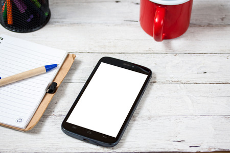 smartphone with notebook and cupon wooden tableの写真素材