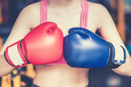 Attractive Female Punching A Bag With Boxing Glovesの写真素材
