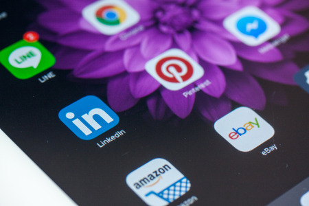 BANGKOK,THAILAND - May 8,2016: Social media icons on screen of iPad and iPhone. Social media are most popular tool for communication, sharing information and content between people in internet.のeditorial素材