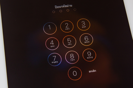 Bangkok, Thailand - Aprill 11,2016 : Apple Ipad2 held in one hand showing its screen with numpad for entering the passcode.のeditorial素材