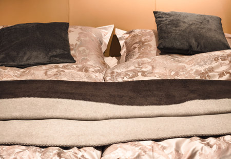 Close up of a bed with pillows in a hotel room.
