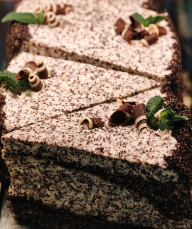 Delicious chocolate cake with cream and mint on table, closeupの写真素材