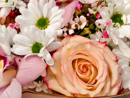 beautiful bouquet of flowers with roses and daisies close upの写真素材