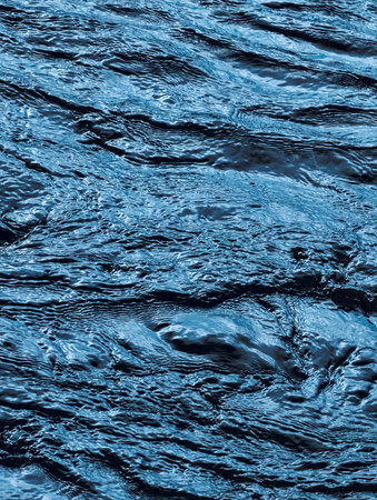 Striking Deep Blue Water Surface with Textured Waves and Glimmers. A Captivating Aquatic Scene Ideal...
