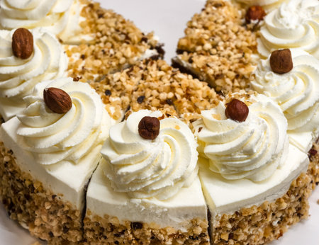 Elegant Almond Cake Slice with Whipped Cream and Nut Crust â Gourmet Dessert for Celebrations, Bakery, Food Styling, and Lifestyle Conceptsの写真素材