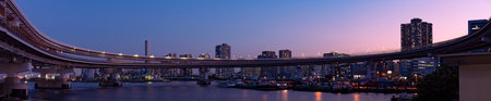 Sunset over Shibaura Loop Bridge and City Skyline, Minato City, Tokyo, Japanの写真素材