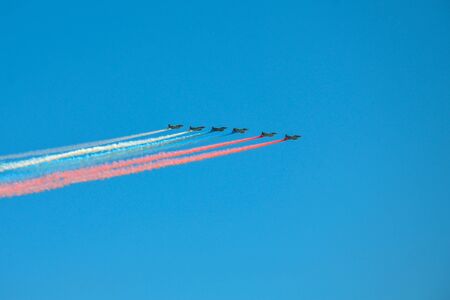 Group of fighters with painted russian flag in the sky on parade of Victory in World War II in Moscow, Russiaの写真素材