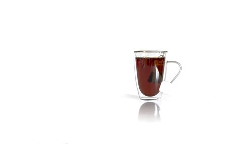 Tea in a glass mug with tea bag. Studio isolated on white background.の写真素材