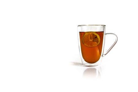 Mug of hot black tea with lemon isolated on white background.の写真素材