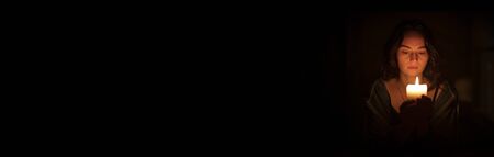 Banner of a sad religious orthodox brunette girl with brown eyes looks piercing and sad looking,...