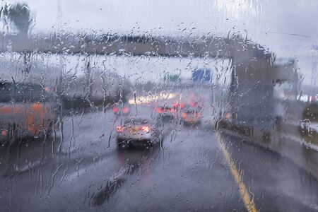 It is raining heavily. It's getting dark on the street. During this, the car drives on a highway or...