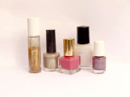 Five bottles of nail polish with shadows, on whiteの写真素材