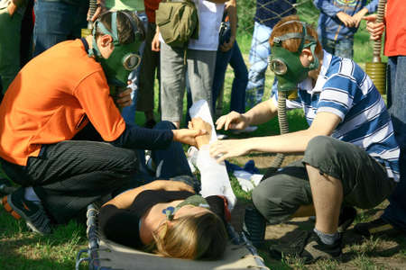 Injured girl, friends treating her injury and on-lookersの写真素材