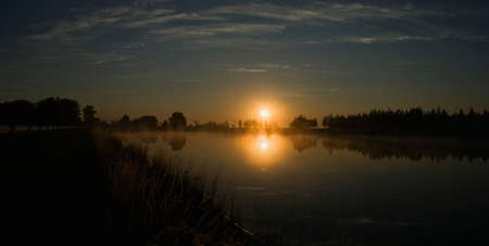 Colorful sunrise on the small lake in Lithuaniaの写真素材